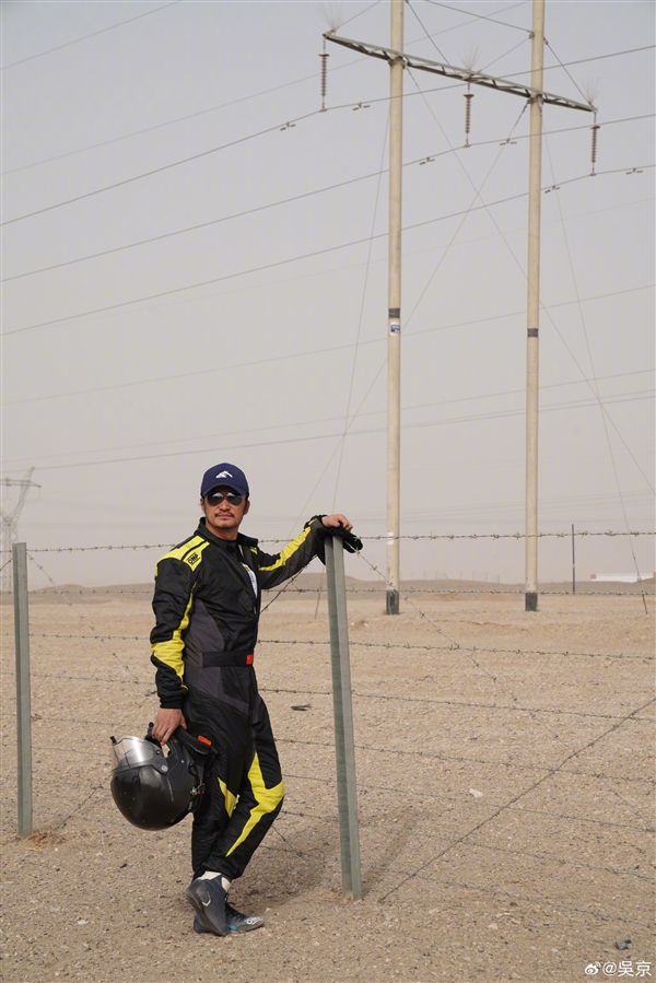 A mechanic repairs Wu Jing's off-road car amid desert terrain
