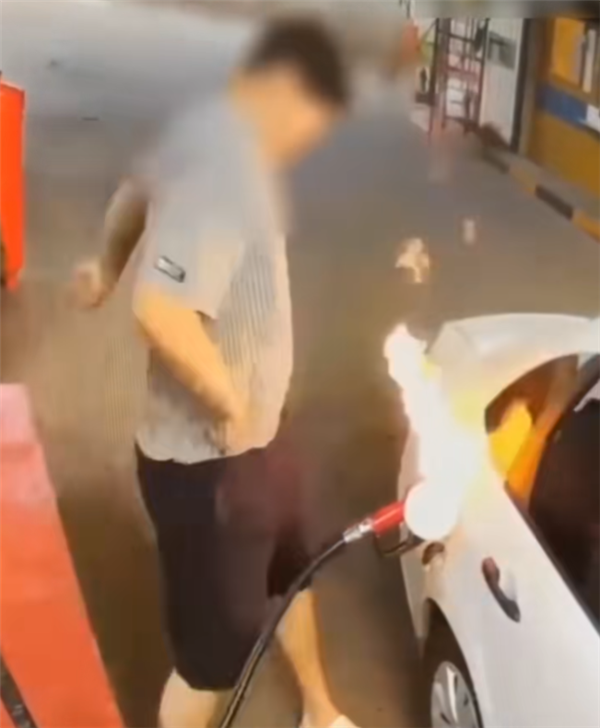 Man's quick hand movement by the fuel tank during refueling ignites his car