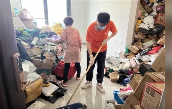 Community workers attempting to manage the enormous pile of boxes inside the apartment