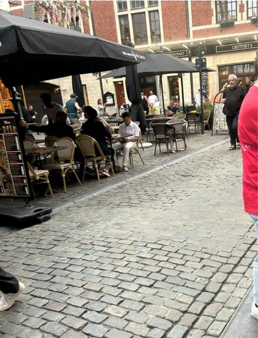 Jack Ma seen in Brussels Grand Place, engrossed in his phone and accompanied by several bodyguards