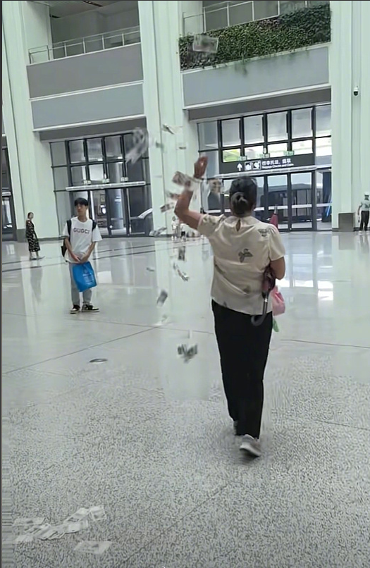 Woman scatters currency at high-speed rail station, raising questions